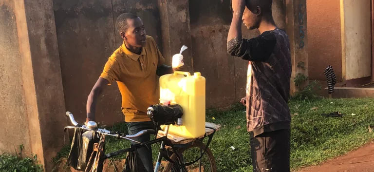 Filling a jerrycan beside a Karaa e-bike