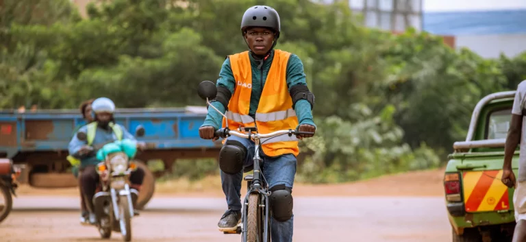 A delivery rider in a hi-vis vest on a Karaa e-bike