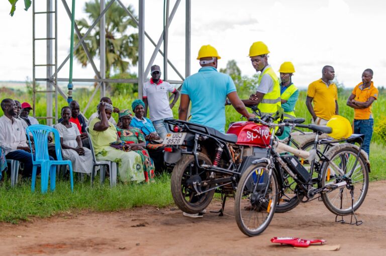 Karaa e-bikes at a mini-grid site, with solar panels behind